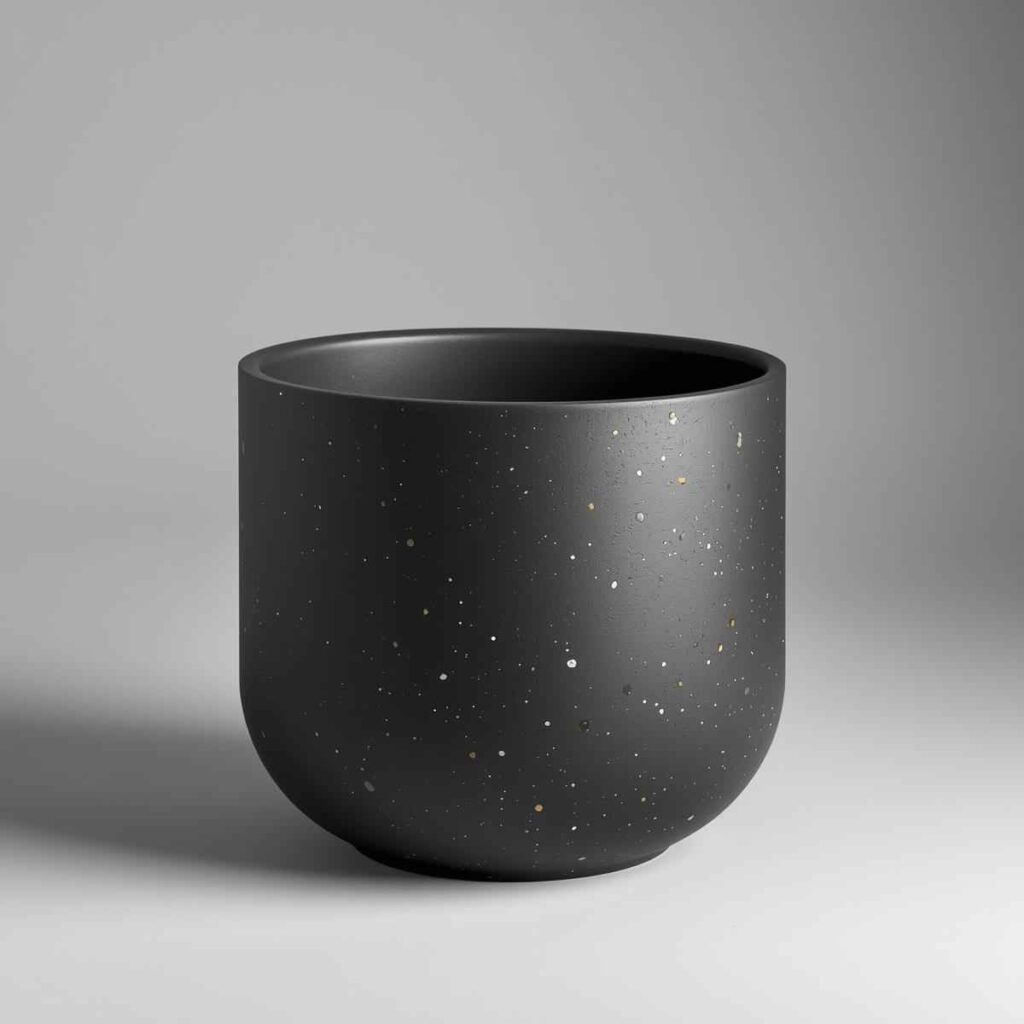 A finished, smooth, matte planter exhibiting a designer finish and subtle terrazzo texture.
