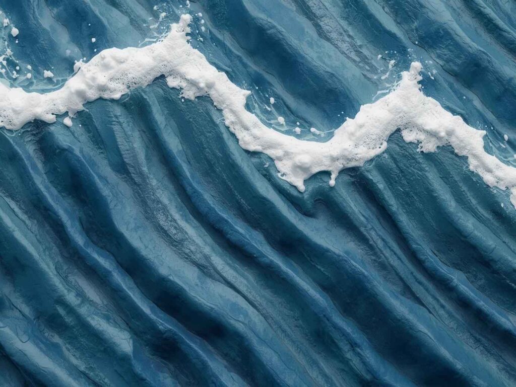 A detailed shot of 3D ocean art with high-texture plaster forming natural wave ridges and white foam.