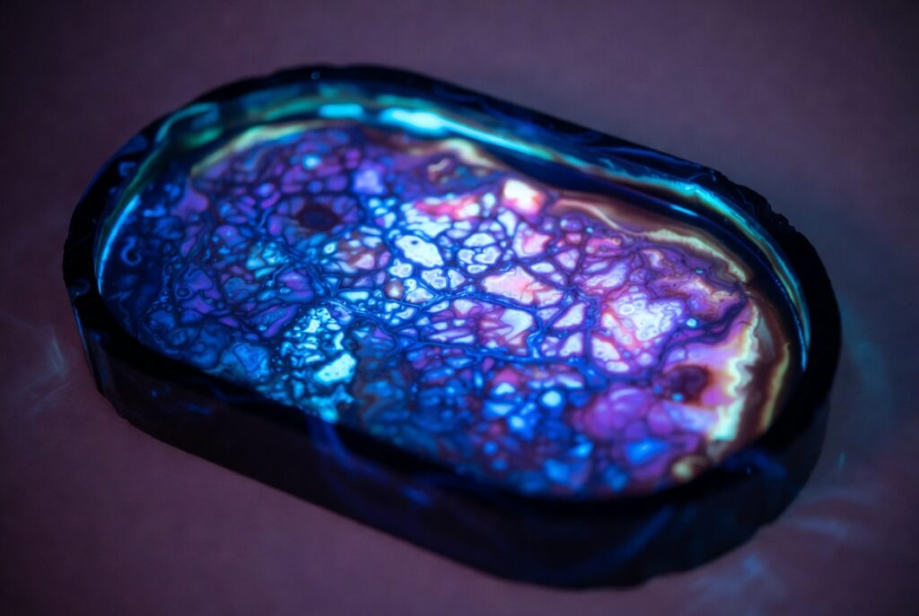 UV-reactive glow resin geode tray that looks black until you shine blacklight on it Filename: glow-resin-geode-tray